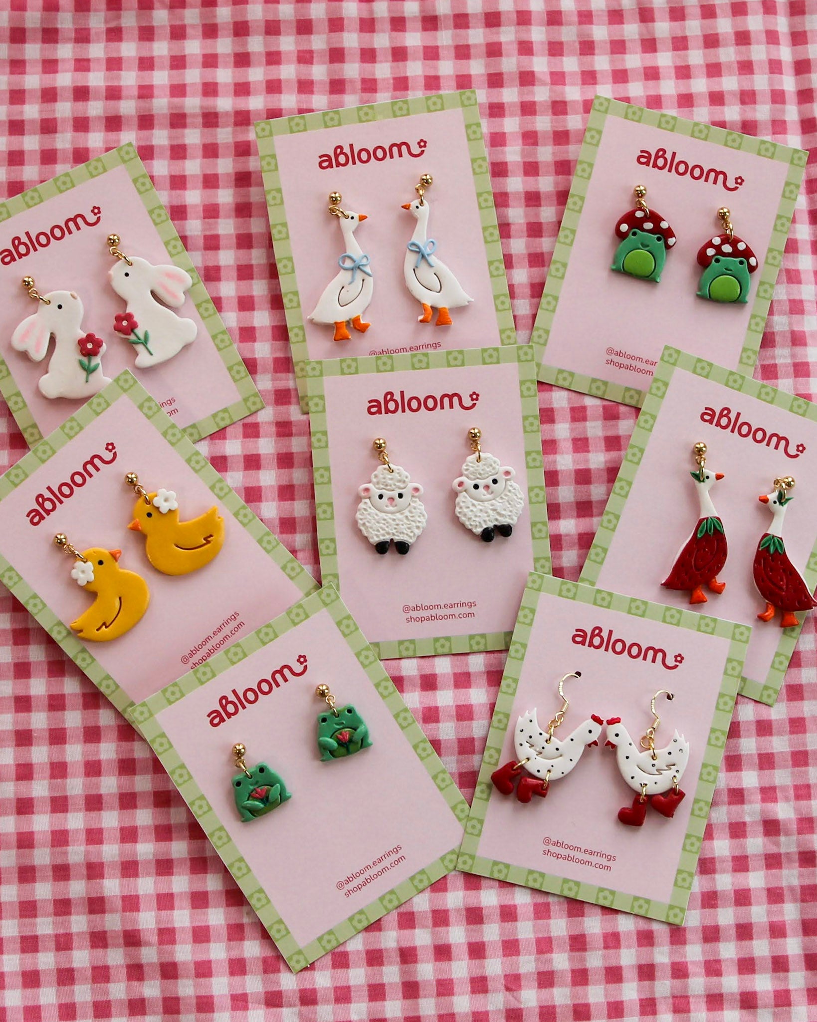 Set of colorful animal earrings on 'abloom' branded cards