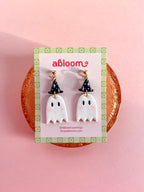 A pair of cute ghost drop earrings with black witch hats.