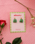 earrings featuring frog/toad's holding a tulip