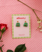earrings featuring frog/toad's holding a tulip