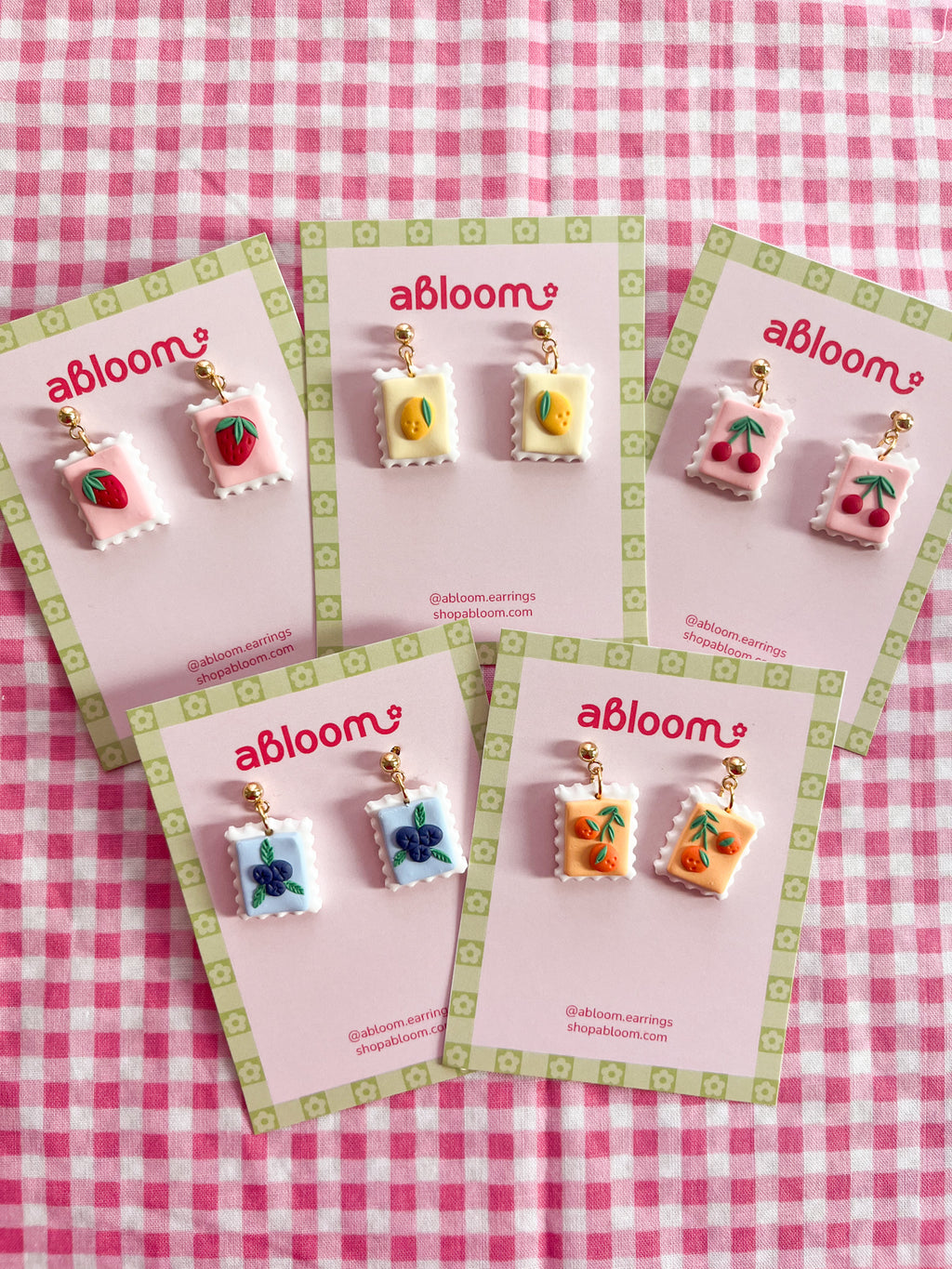 Cute whimsical fruit postage stamp earrings handmade from polymer clay