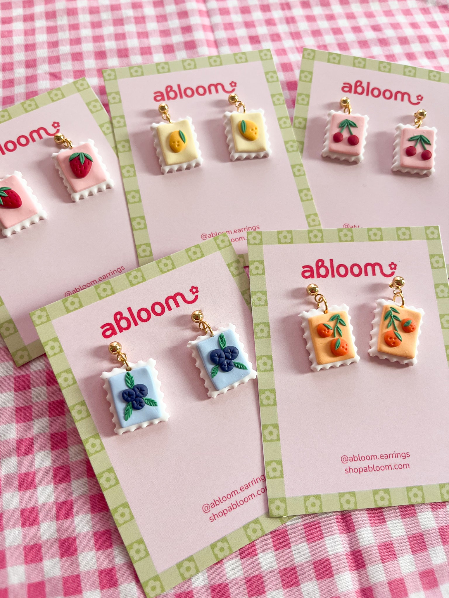 Cute whimsical fruit postage stamp earrings handmade from polymer clay