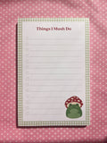 A lined to-do list notepad with the title "Things I Mush Do" and featuring a mushroom frog illustration in the bottom right corner. 