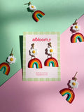 cute rainbow earrings with a white flower on top