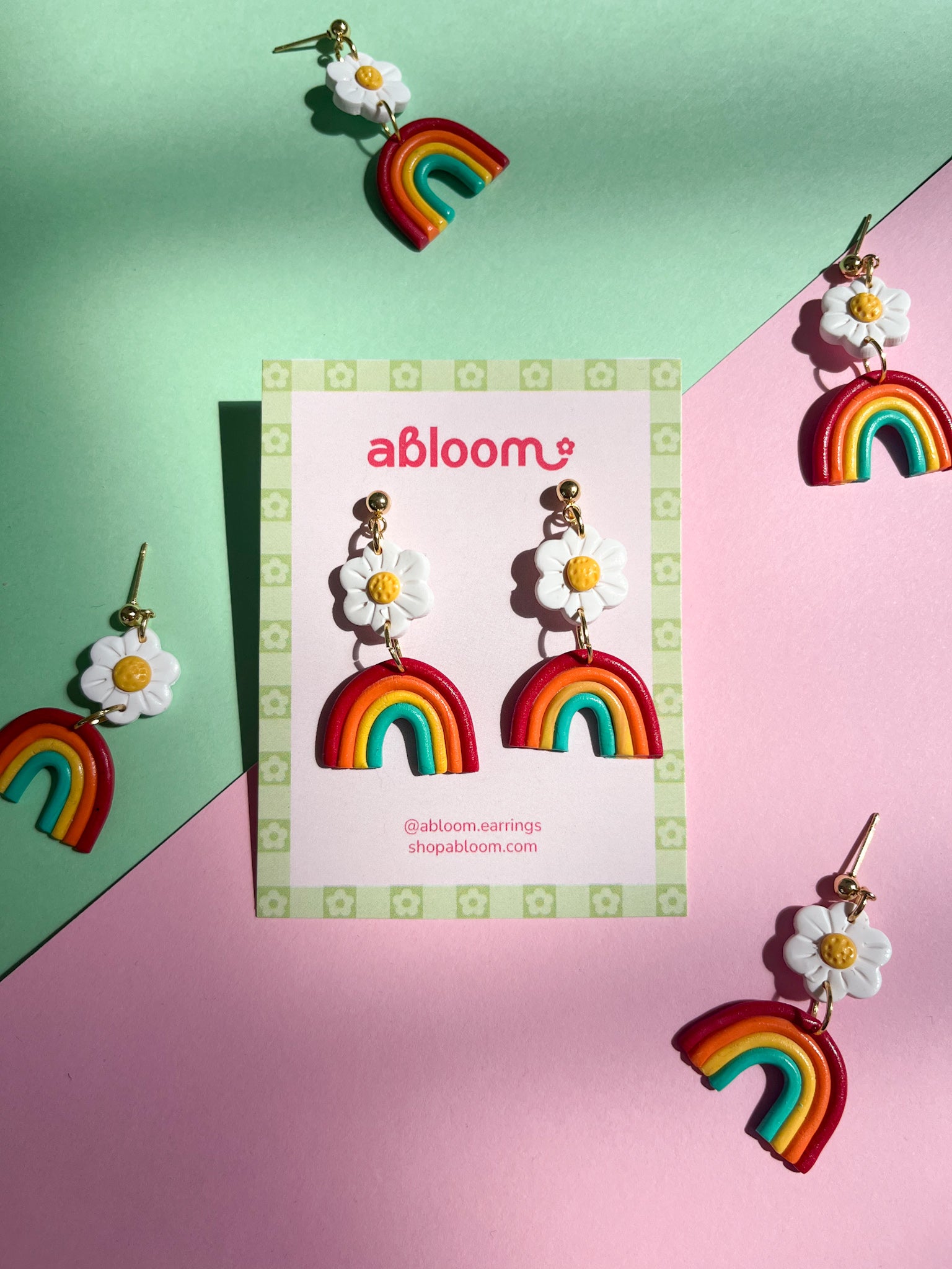 cute rainbow earrings with a white flower on top