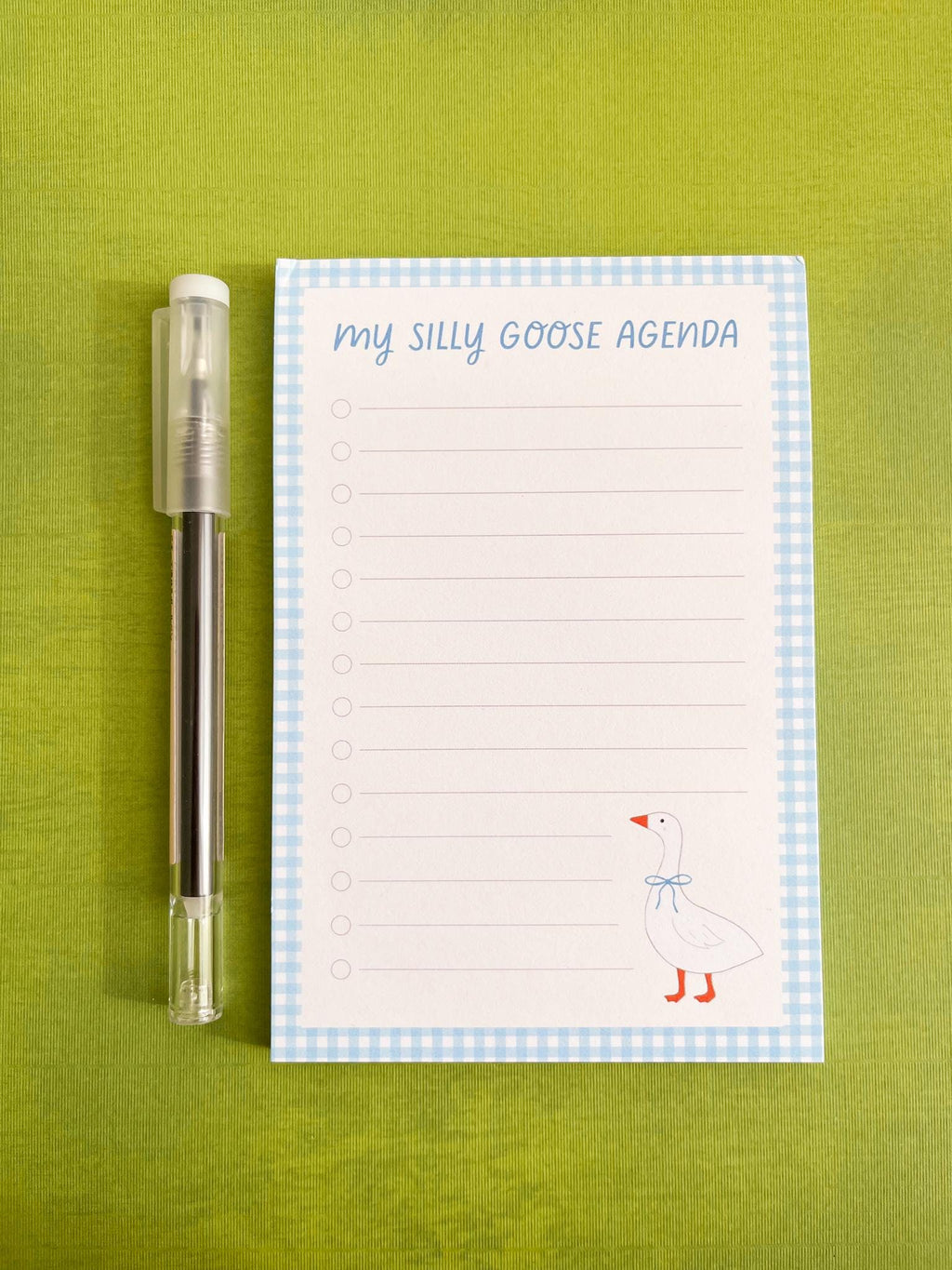 Lined notepad with 'My Silly Goose Agenda' title, lines with checkboxes, a blue gingham trim, and a illustrated goose in the right bottom corner