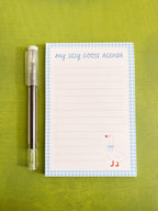 Lined notepad with 'My Silly Goose Agenda' title, lines with checkboxes, a blue gingham trim, and a illustrated goose in the right bottom corner