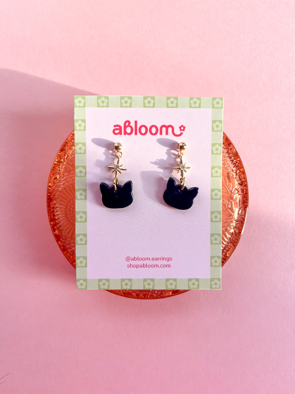 Cute black cat earrings with sparkling star charm handmade from polymer clay
