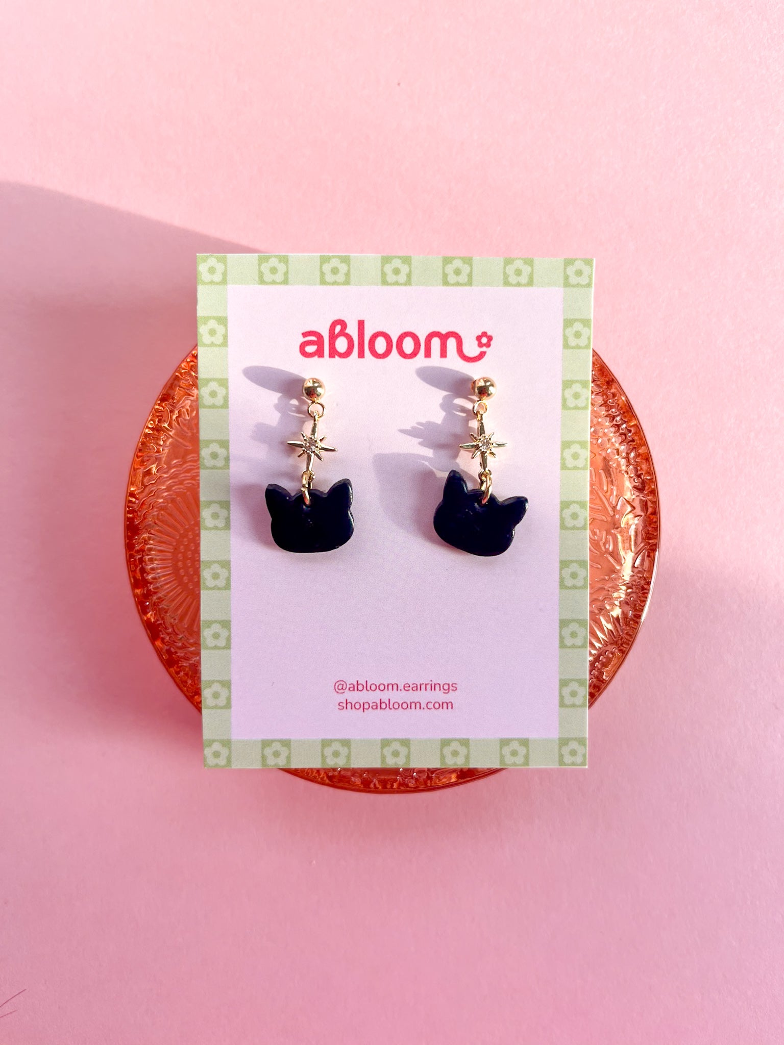 Cute black cat earrings with sparkling star charm handmade from polymer clay