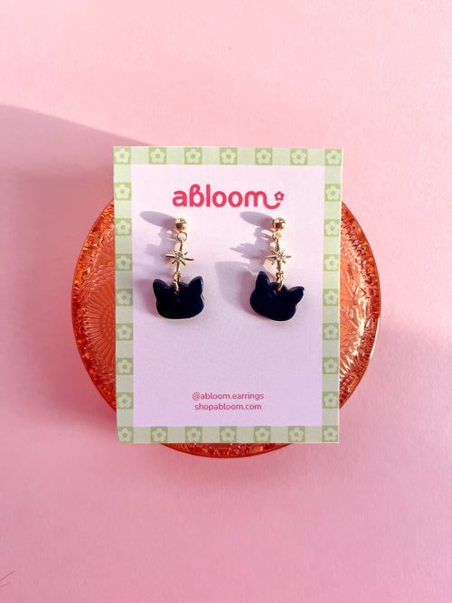 Cute black cat earrings with sparkling star charm handmade from polymer clay