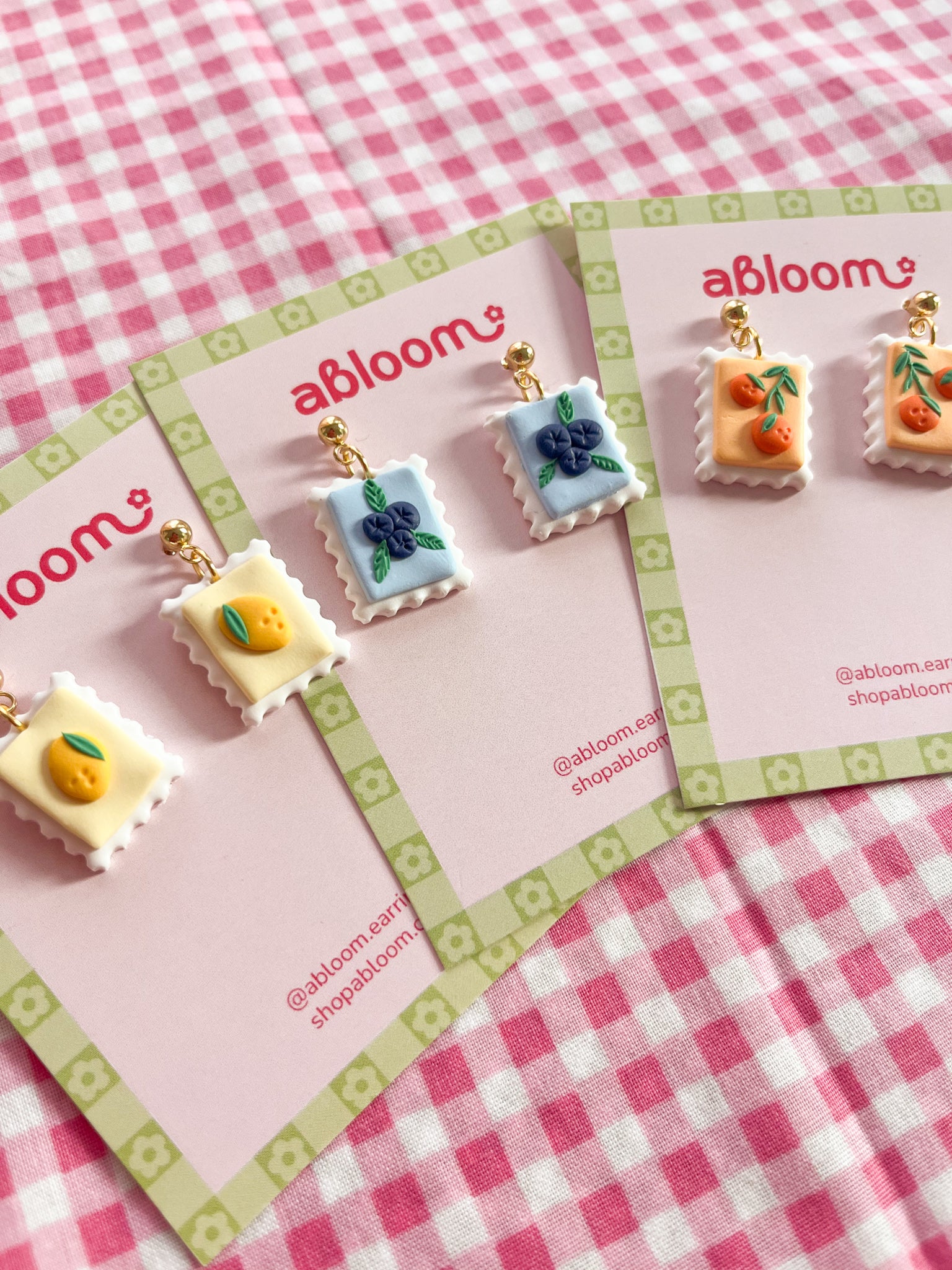Cute whimsical fruit postage stamp earrings handmade from polymer clay