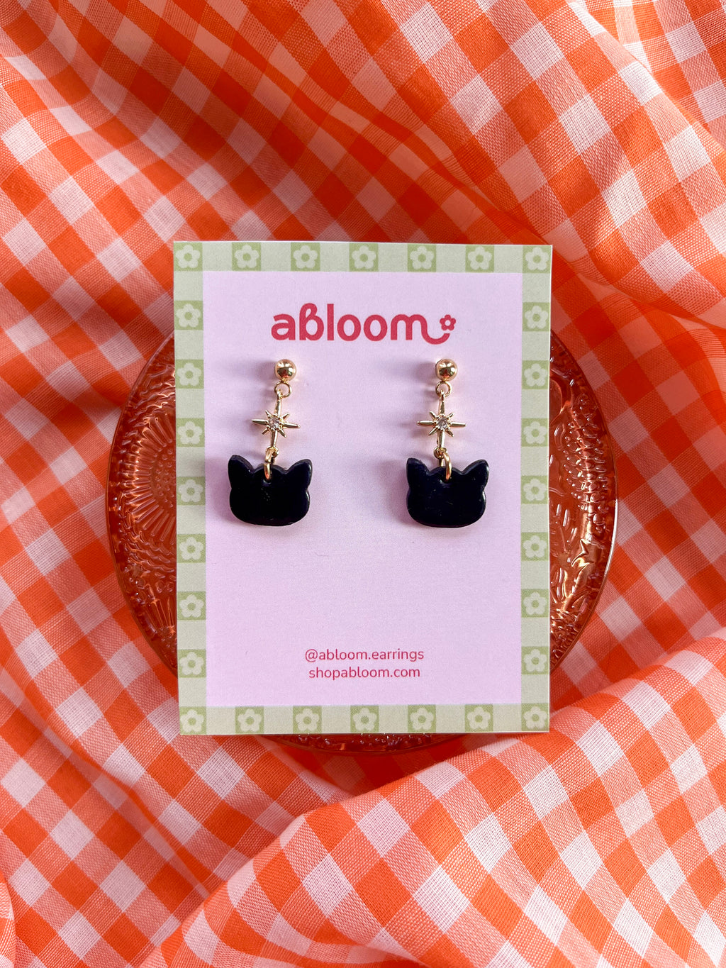 Cute black cat earrings with sparkling star charm handmade from polymer clay