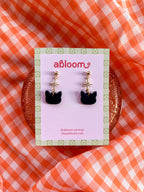 Cute black cat earrings with sparkling star charm handmade from polymer clay