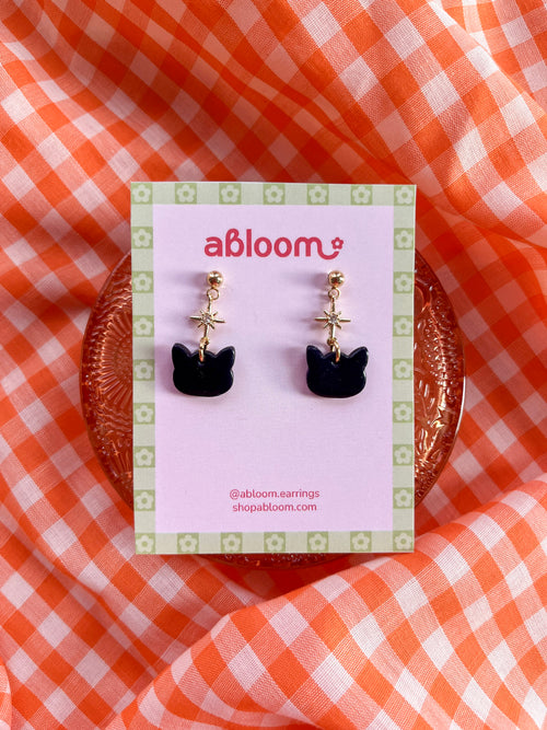 Cute black cat earrings with sparkling star charm handmade from polymer clay