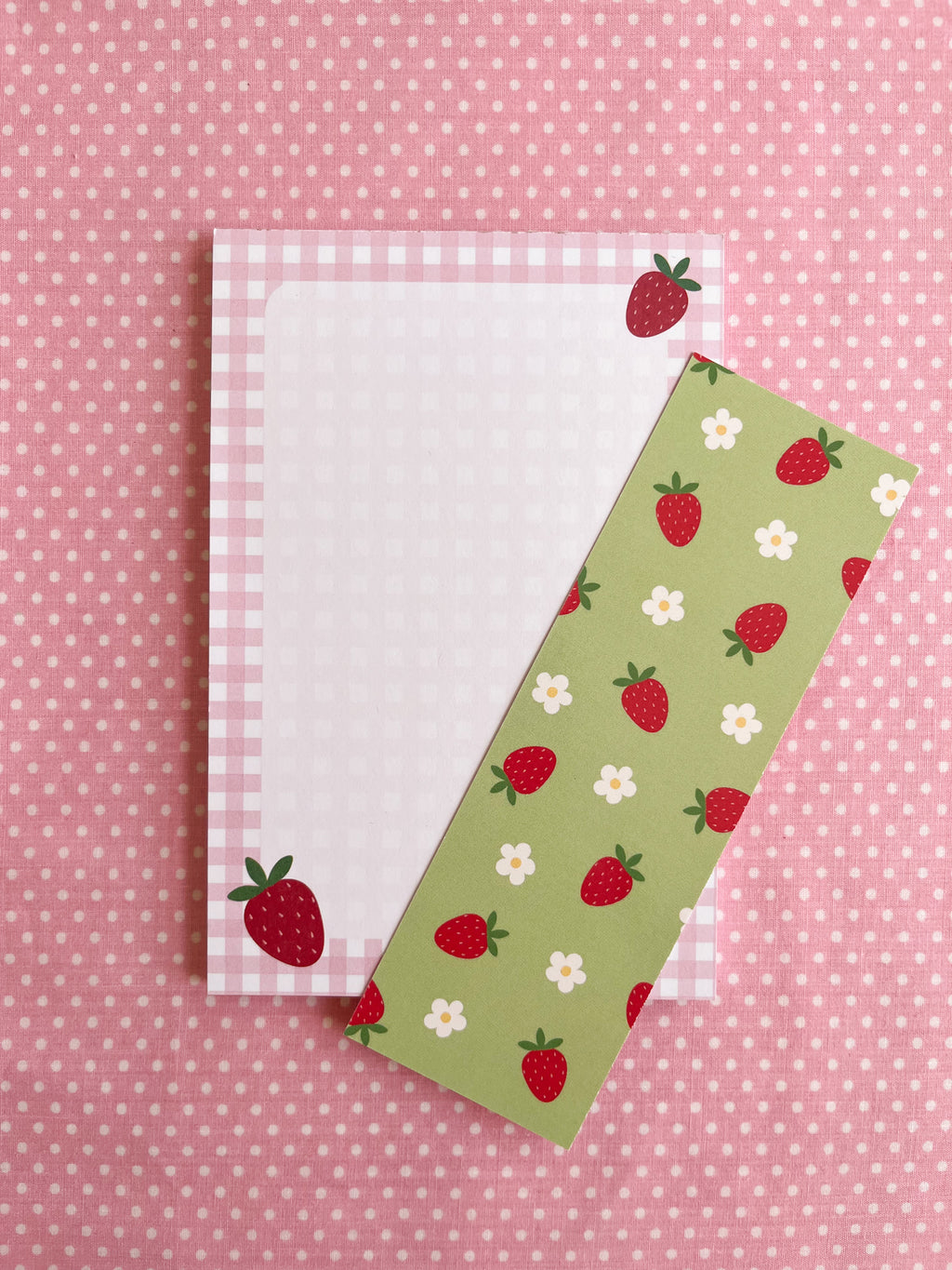 notepad and bookmark with strawberry patterns on a pink polka dot background