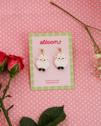 white sheep earrings on an abloom branded earring card