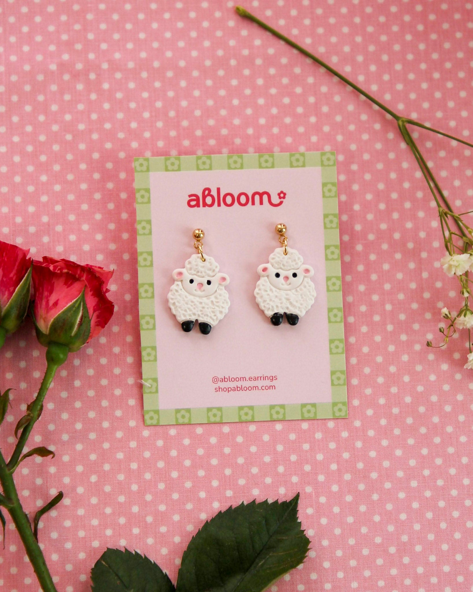 white sheep earrings on an abloom branded earring card