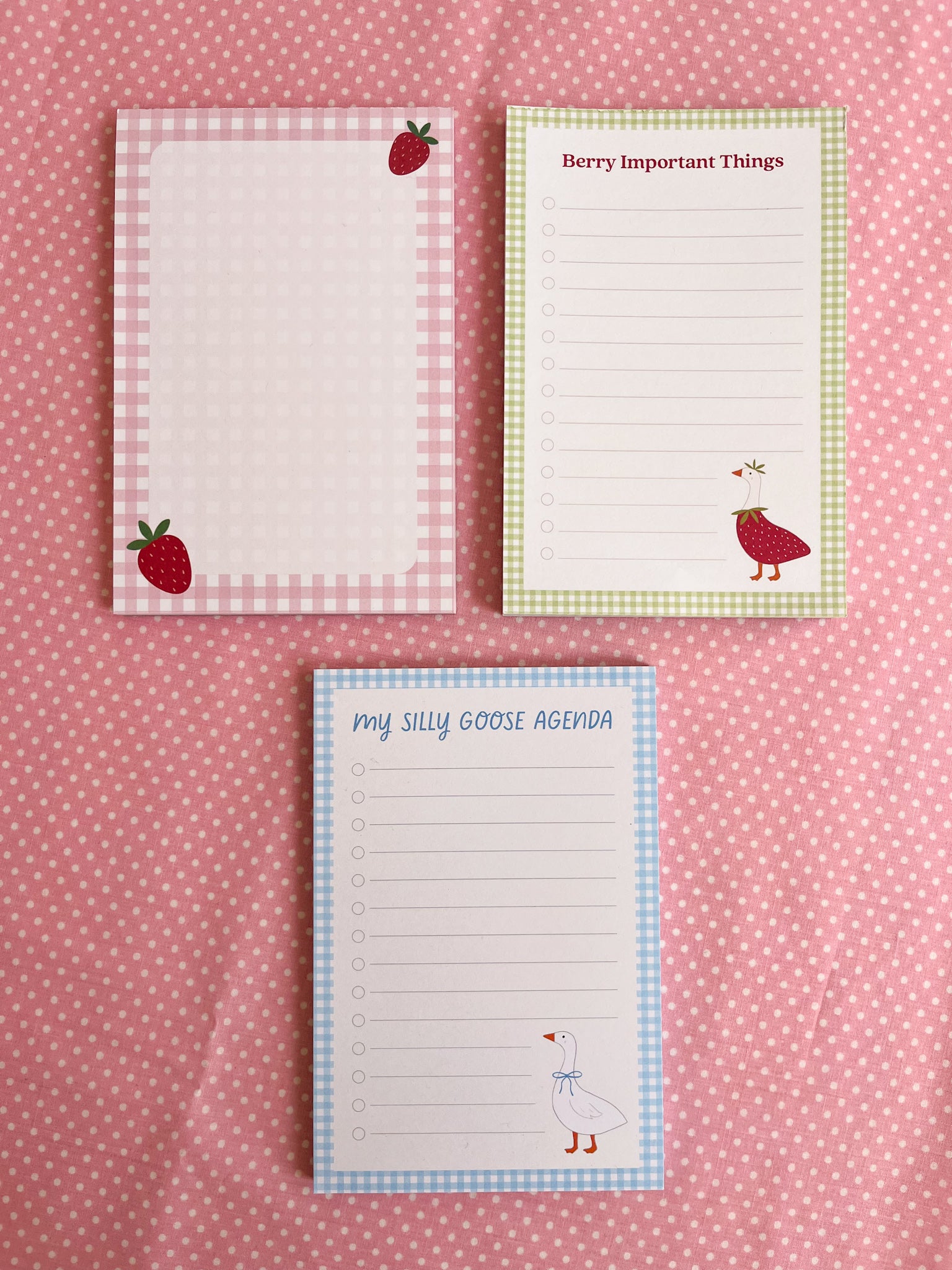 Three notepads with strawberry and goose designs 