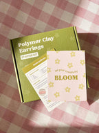 Polymer clay earrings starter kit with instructions on a checkered tablecloth