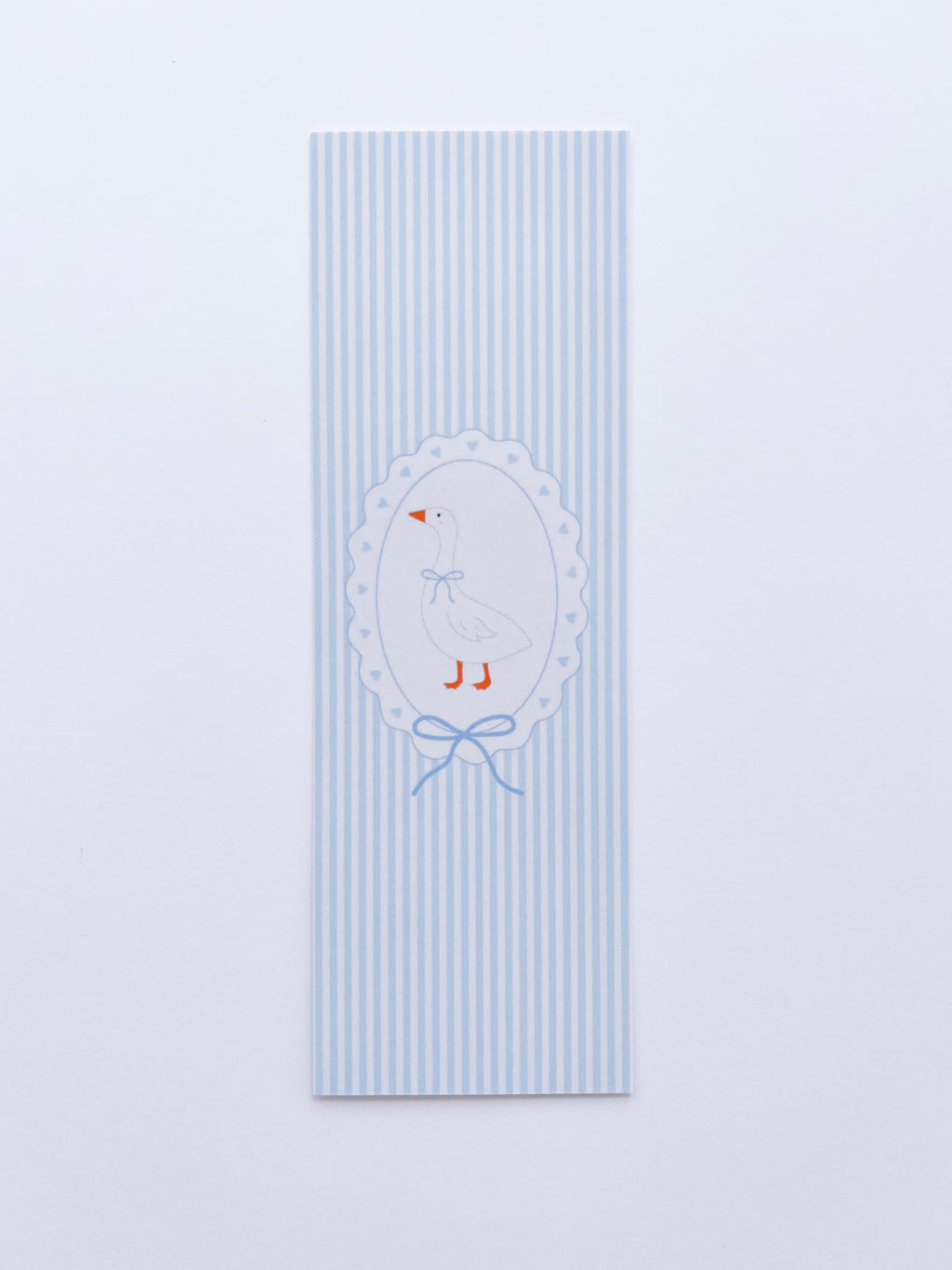 bookmark featuring a goose illustration on a frame on blue and white stripped background