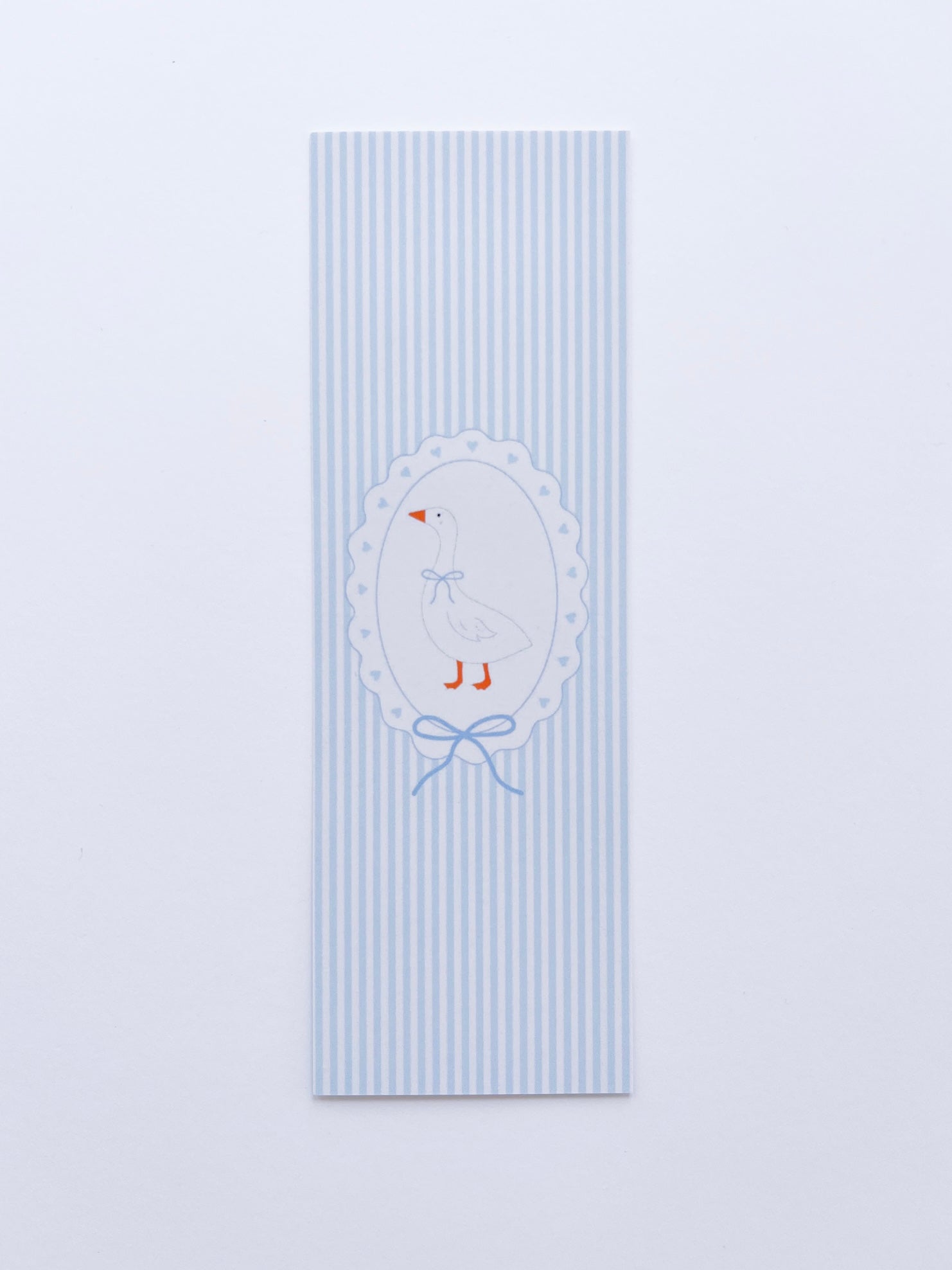 bookmark featuring a goose illustration on a frame on blue and white stripped background